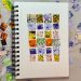 Image of an art-journal page with pieces of colorful hand-painted paper cut into squares and arranged in a rectangle to represent a quilt.