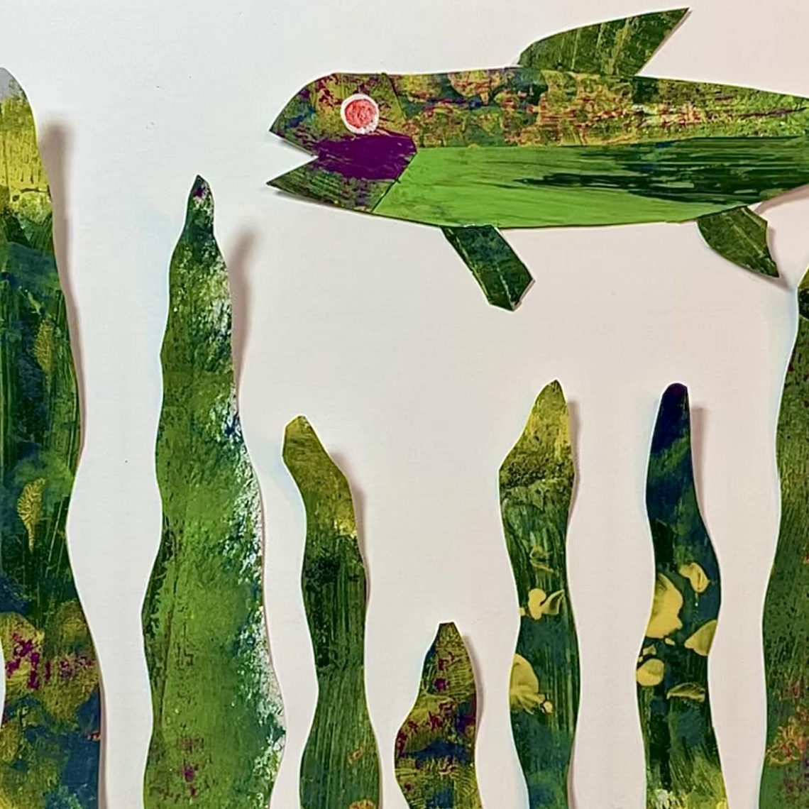 Cut paper fish in shades of green with yellow and magenta. Eric Carle style.