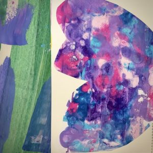 Abstract cut-paper butterfly wing in purples, pinks, and blues on art journal page