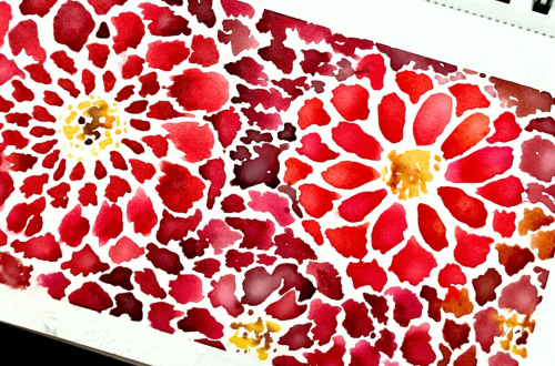 abstract red watercolor flowers with yellow centers filling spiral-bound art journal page