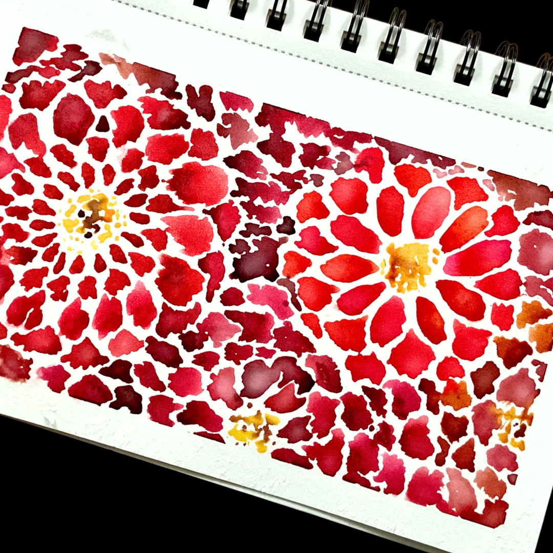 abstract red watercolor flowers with yellow centers filling spiral-bound art journal page
