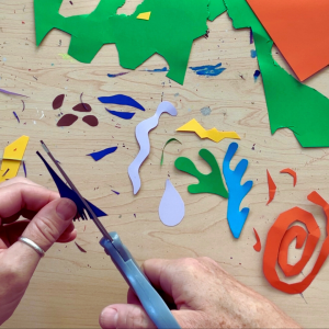 Hand cutting Matisse-inspired shapes from colored card stock.
